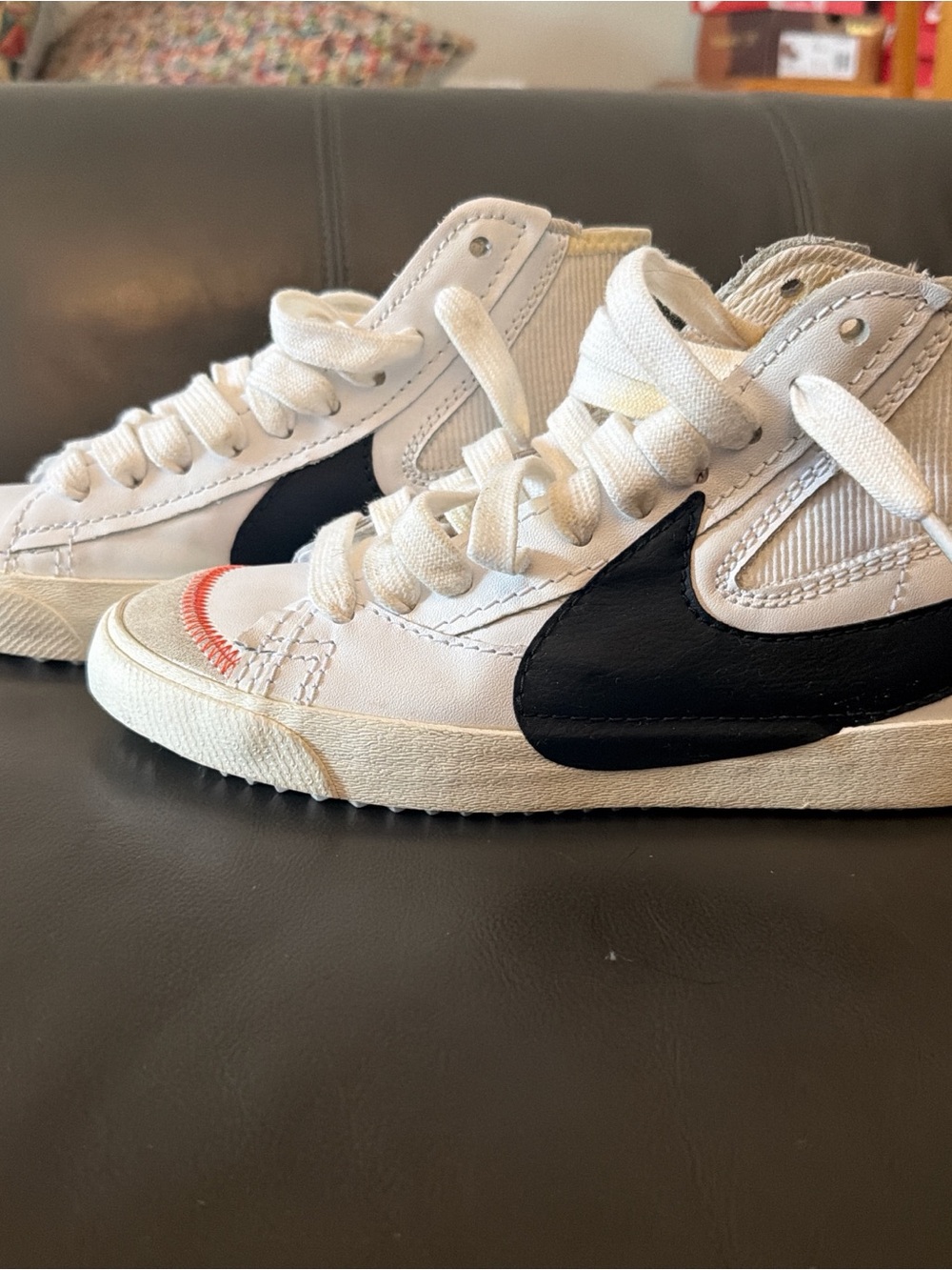 Nike Kids White High-Top Sneakers with Black Swoosh and Red Toe Accent